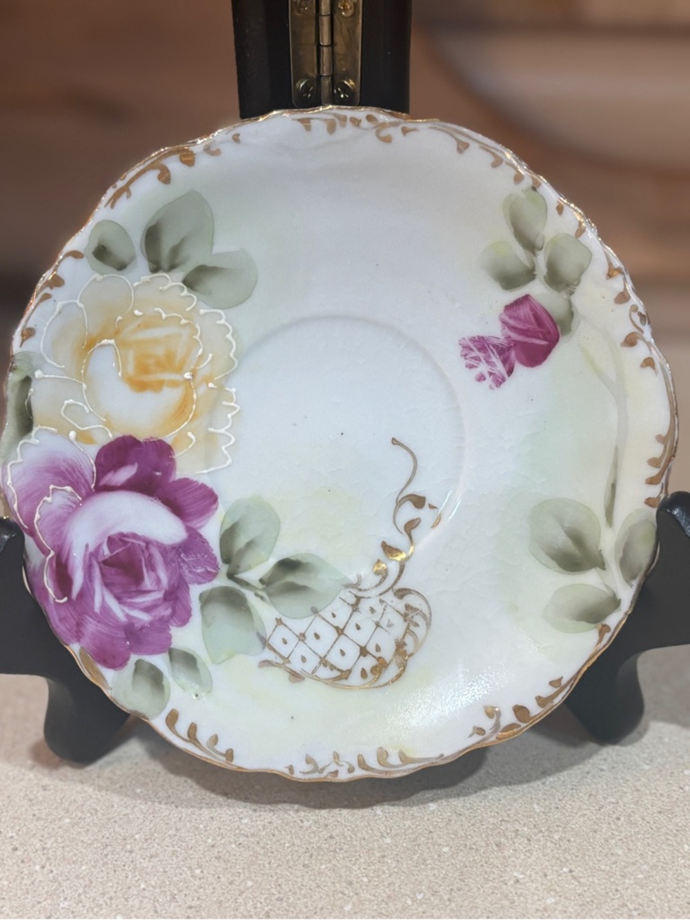 A vintage Japanese hand-painted porcelain teacup saucer
